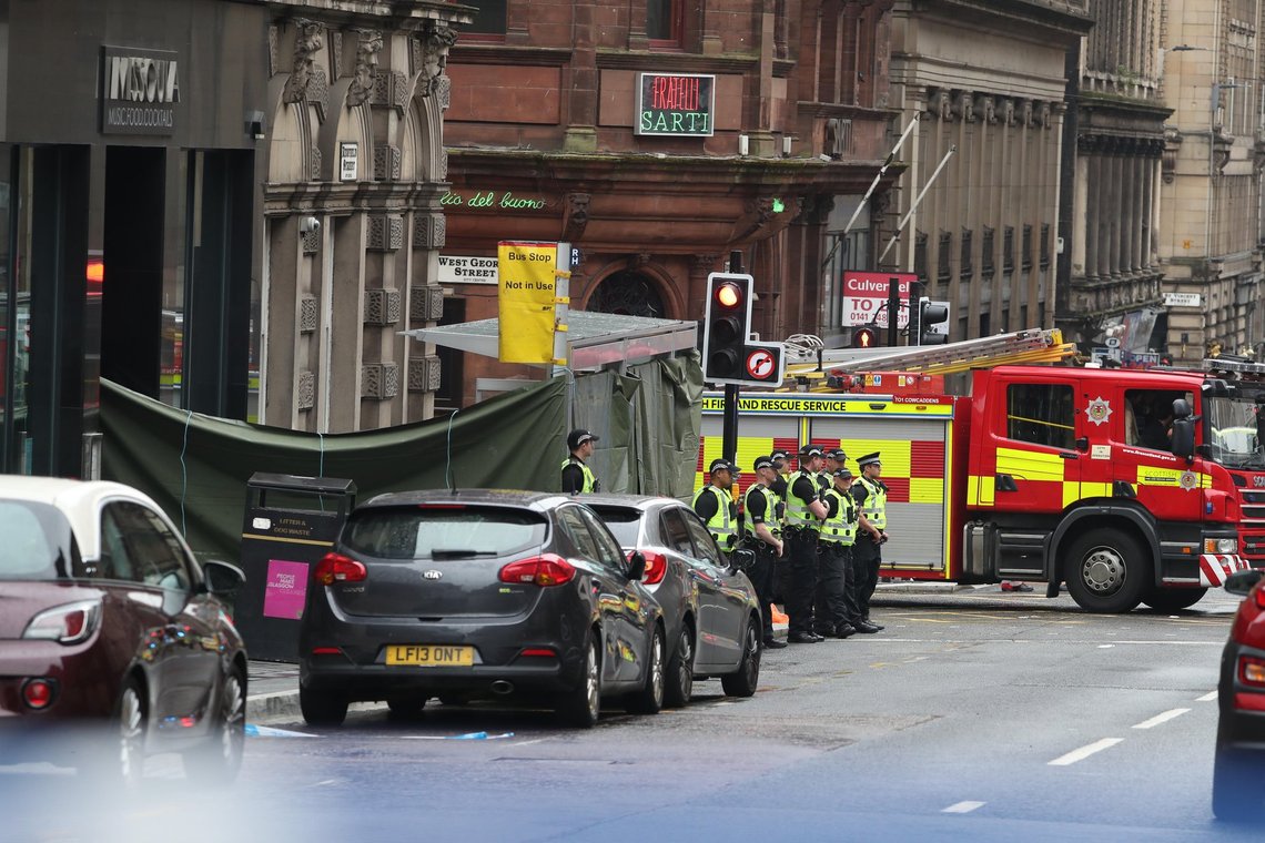 Emergency services at the scene in West George Street, Glasgow, where a man has been shot by an armed officer after another police officer was injured during an attack. Emergency services at the scene in West George Street, Glasgow, where a man has been shot by an armed officer after another police officer was injured during an attack.