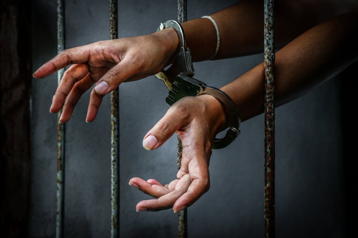 Prisoner in prison with handcuff Prisoner in prison with handcuff