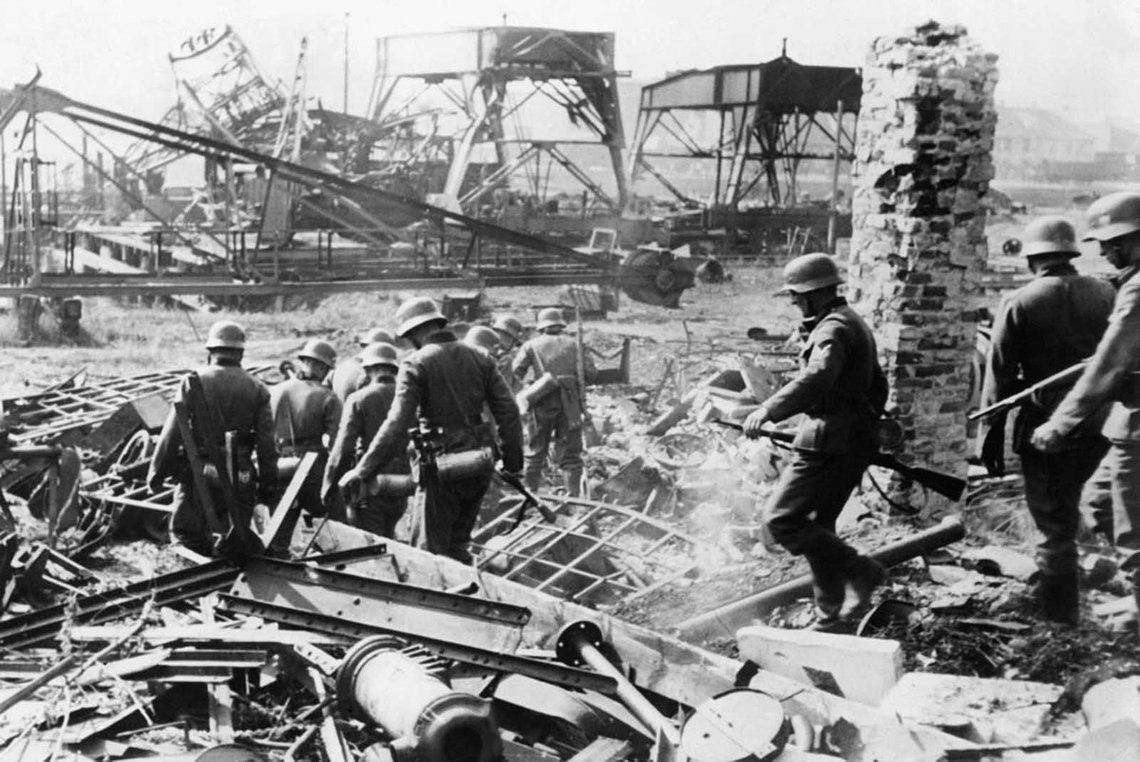 German soldiers comb the Westerplatte after it was surrendered to German units from the Schleswig-Holstein landing crew, on September 7, 1939. Fewer than 200 Polish soldiers defended the small peninsula, holding off the Germans for seven days. German soldiers comb the Westerplatte after it was surrendered to German units from the Schleswig-Holstein landing crew, on September 7, 1939. Fewer than 200 Polish soldiers defended the small peninsula, holding off the Germans for seven days.