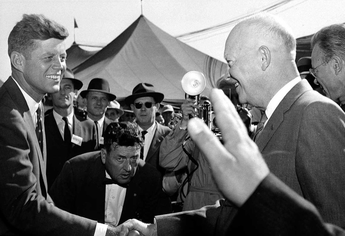 Senator John F. Kennedy greets President Dwight D. Eisenhower on his arrival for festivities at the National Corn Picking Contest near Cedar Rapids, Iowa, on October 17, 1958. Senator John F. Kennedy greets President Dwight D. Eisenhower on his arrival for festivities at the National Corn Picking Contest near Cedar Rapids, Iowa, on October 17, 1958.