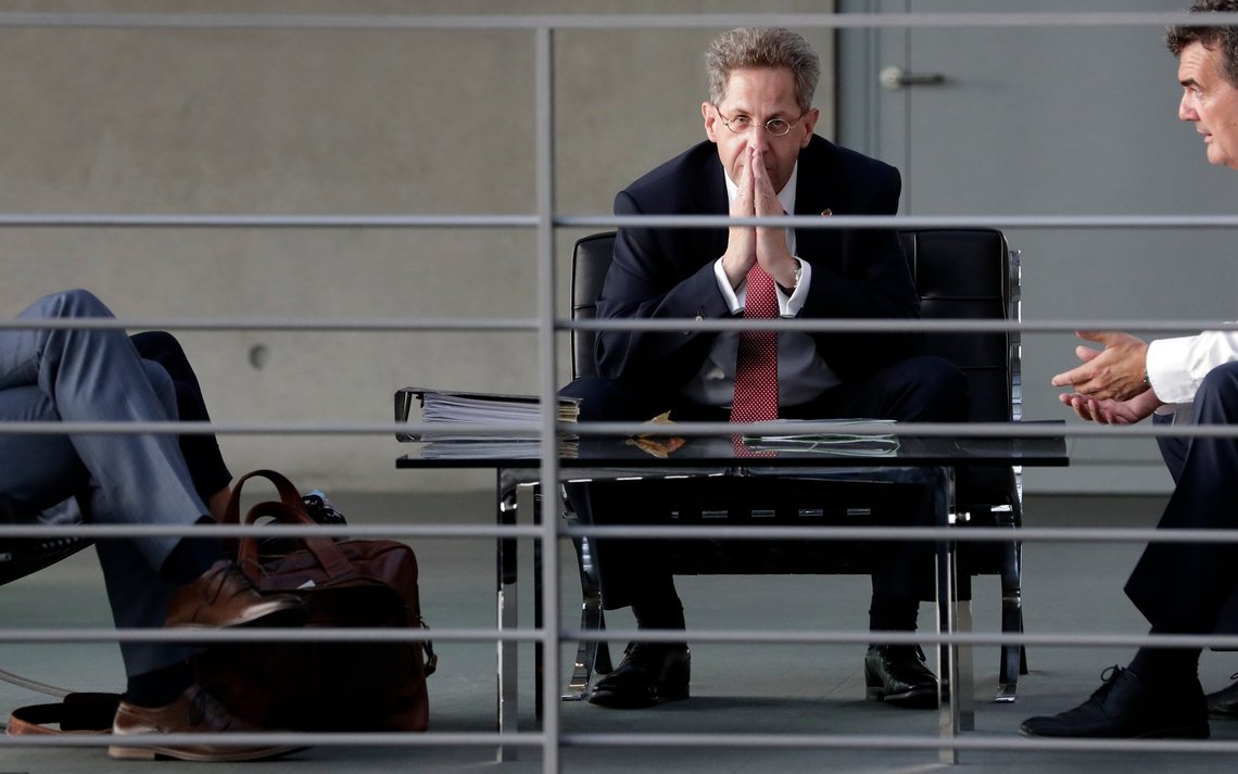FILE-- In this Wednesday, Sept. 12, 2018 photo Hans-Georg Maassen, center, head of the German Federal Office for the Protection of the Constitution, waits for the beginning of a hearing at the home affairs committee of the German federal parliament, Bundestag, in Berlin, Germany. The leaders of Germany's three governing parties are meeting in Berlin on Tuesday to decide the fate of the country's domestic intelligence chief amid calls for him to be fired over his approach to far-right extremism. (AP Photo/Michael Sohn, file) FILE-- In this Wednesday, Sept. 12, 2018 photo Hans-Georg Maassen, center, head of the German Federal Office for the Protection of the Constitution, waits for the beginning of a hearing at the home affairs committee of the German federal parliament, Bundestag, in Berlin, Germany. The leaders of Germany's three governing parties are meeting in Berlin on Tuesday to decide the fate of the country's domestic intelligence chief amid calls for him to be fired over his approach to far-right extremism. (AP Photo/Michael Sohn, file)