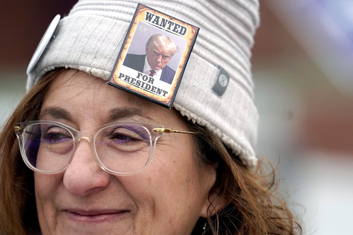 Linda McGrath, of Hampton, N.H., a supporter of Donald Trump, wears a hat with a button featuring a likeness of the former president, Tuesday, Jan. 23, 2024, near a polling site at Winnacunnet High School in Hampton, N.H. (AP Photo/Steven Senne) Linda McGrath, of Hampton, N.H., a supporter of Donald Trump, wears a hat with a button featuring a likeness of the former president, Tuesday, Jan. 23, 2024, near a polling site at Winnacunnet High School in Hampton, N.H. (AP Photo/Steven Senne)