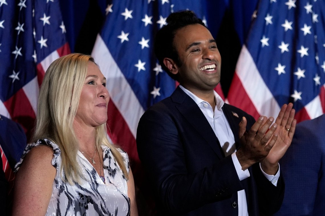 Rep. Marjorie Taylor Greene, R-Ga., and Vivek Ramaswamy listen as Republican presidential candidate former President Donald Trump speaks at a primary election night party in Nashua, N.H., Tuesday, Jan. 23, 2024. (AP Photo/Matt Rourke) Rep. Marjorie Taylor Greene, R-Ga., and Vivek Ramaswamy listen as Republican presidential candidate former President Donald Trump speaks at a primary election night party in Nashua, N.H., Tuesday, Jan. 23, 2024. (AP Photo/Matt Rourke)