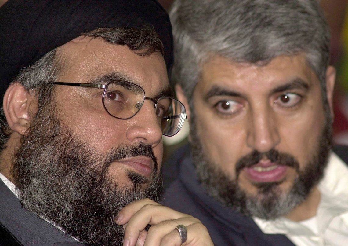 FILE - Sheik Hassan Nasrallah, leader of Hezbollah, left, chats with Khaled Mashaal, in south of Beirut, Lebanon, March 27, 2004. The gas-rich nation of Qatar has become a key intermediary over the fate of some 200 hostages held by Hamas after their unprecedented attack on Israel, once again putting the small Arabian Peninsula in the spotlight. (AP Photo/Hassan Ammar, File) FILE - Sheik Hassan Nasrallah, leader of Hezbollah, left, chats with Khaled Mashaal, in south of Beirut, Lebanon, March 27, 2004. The gas-rich nation of Qatar has become a key intermediary over the fate of some 200 hostages held by Hamas after their unprecedented attack on Israel, once again putting the small Arabian Peninsula in the spotlight. (AP Photo/Hassan Ammar, File)