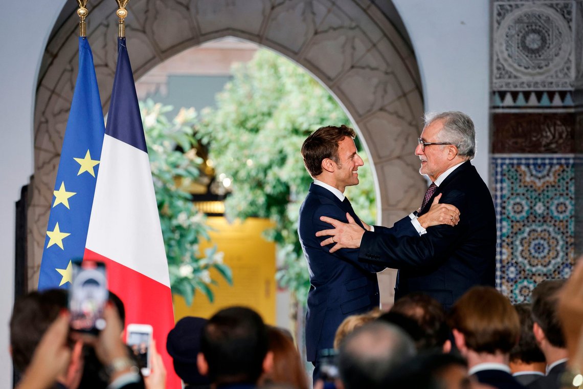 French President Emmanuel Macron, left, holds Franco-Algerian lawyer and Rector of Paris' Grand Mosque Chems-eddine Hafiz after giving him the highest French order of merit "Legion dHonneur" during a visit for the commemorative century exposition of the opening of the Grande Mosque of Paris, in Paris, Wednesday Oct. 19, 2022. (Ludovic Marin/Pool via AP) French President Emmanuel Macron, left, holds Franco-Algerian lawyer and Rector of Paris' Grand Mosque Chems-eddine Hafiz after giving him the highest French order of merit "Legion dHonneur" during a visit for the commemorative century exposition of the opening of the Grande Mosque of Paris, in Paris, Wednesday Oct. 19, 2022. (Ludovic Marin/Pool via AP)
