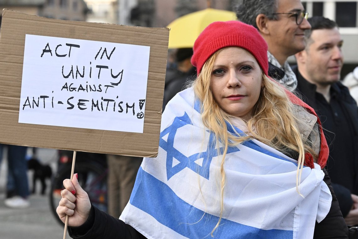 People take part in vigil at the Helvetia square in Zurich, Switzerland, Sunday, March 3, 2024. On Saturday evening, a young man had stabbed an orthodox Jew. (Walter Bieri/Keystone via AP) People take part in vigil at the Helvetia square in Zurich, Switzerland, Sunday, March 3, 2024. On Saturday evening, a young man had stabbed an orthodox Jew. (Walter Bieri/Keystone via AP)
