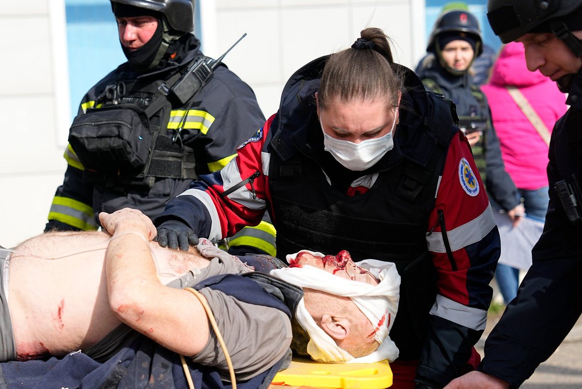 Medics evacuate a wounded man at the site of a Russian attack in Kharkiv, Ukraine, Wednesday, March 20, 2024. (AP Photo/Efrem Lukatsky) Medics evacuate a wounded man at the site of a Russian attack in Kharkiv, Ukraine, Wednesday, March 20, 2024. (AP Photo/Efrem Lukatsky)