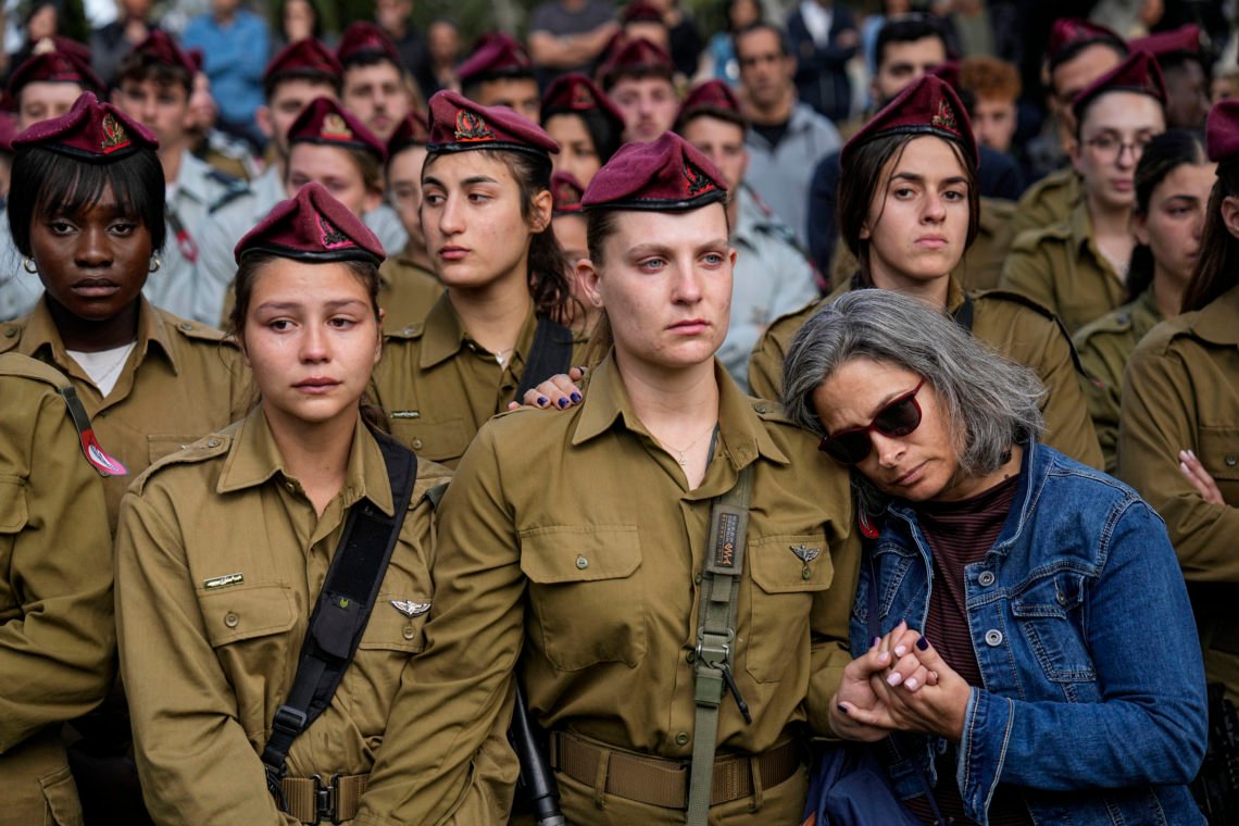 Israeli soldiers mourners in grief during the funeral of Israeli solider Staff sergeant David Sasson, in Netanya, Israel, Thursday, March 7, 2024. Sasson, 21, was killed during Israel's ground operation in the Gaza Strip, where the Israeli army has been battling Palestinian militants in the war ignited by Hamas' Oct. 7 attack into Israel. (AP Photo/Ariel Schalit) Israeli soldiers mourners in grief during the funeral of Israeli solider Staff sergeant David Sasson, in Netanya, Israel, Thursday, March 7, 2024. Sasson, 21, was killed during Israel's ground operation in the Gaza Strip, where the Israeli army has been battling Palestinian militants in the war ignited by Hamas' Oct. 7 attack into Israel. (AP Photo/Ariel Schalit)