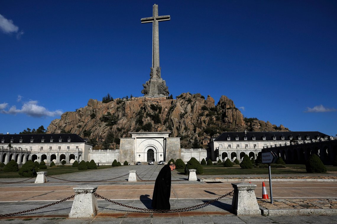 FILE - A friar walks in front of the Valle de los Caidos (Valley of the Fallen) mausoleum on the outskirts of Madrid, Spain, on Oct. 13, 2019. Initial forensic work has begun on Monday June 12, 2023 to try to exhume the bodies of 128 victims of late dictator Francisco Franco's forces who are among tens of thousands of people buried anonymously in the Valle de Cuelgamuros. mausoleum, formerly known as the Valle de los Caídos, or Valley of the Fallen. The exhumations, if successful, will be the first for victims under Spain's historical memory law that is aimed at making reparations to the victims. (AP Photo/Manu Fernandez, File) FILE - A friar walks in front of the Valle de los Caidos (Valley of the Fallen) mausoleum on the outskirts of Madrid, Spain, on Oct. 13, 2019. Initial forensic work has begun on Monday June 12, 2023 to try to exhume the bodies of 128 victims of late dictator Francisco Franco's forces who are among tens of thousands of people buried anonymously in the Valle de Cuelgamuros. mausoleum, formerly known as the Valle de los Caídos, or Valley of the Fallen. The exhumations, if successful, will be the first for victims under Spain's historical memory law that is aimed at making reparations to the victims. (AP Photo/Manu Fernandez, File)