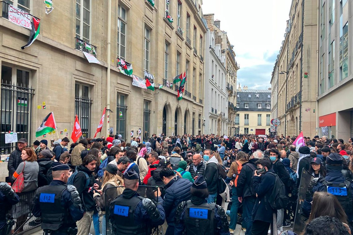 Police officers watch students outside the Sciences-Po university Friday, April 26, 2024 in Paris. Students in Paris inspired by Gaza solidarity encampments at campuses in the United States blocked access to a campus building at a prestigious French university Friday, prompting administrators to move all classes online. The pro-Palestinian protest at the Paris Institute of Political Studies, known as Sciences Po, came two days after police broke up a separate demonstration at one of the university's amphitheaters. (AP Photo/Jeffrey Schaeffer) Police officers watch students outside the Sciences-Po university Friday, April 26, 2024 in Paris. Students in Paris inspired by Gaza solidarity encampments at campuses in the United States blocked access to a campus building at a prestigious French university Friday, prompting administrators to move all classes online. The pro-Palestinian protest at the Paris Institute of Political Studies, known as Sciences Po, came two days after police broke up a separate demonstration at one of the university's amphitheaters. (AP Photo/Jeffrey Schaeffer)