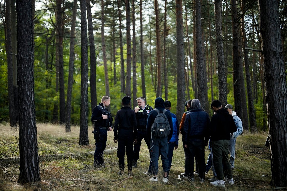 FILE - A Federal Police officer speaks into his radio as he and a colleague track down a group of migrants who have illegally crossed the border from Poland into Germany, while on patrol in a forest near Forst south east of Berlin, Germany, on Oct. 11, 2023. European Union leaders and top officials hailed on Wednesday Dec. 20, 2023 a major breakthrough in talks on new rules to control migration, but critics said the reforms will weaken the rights of asylum-seekers and encourage more morally dubious deals with countries that people leave to get to Europe. (AP Photo/Markus Schreiber, File) FILE - A Federal Police officer speaks into his radio as he and a colleague track down a group of migrants who have illegally crossed the border from Poland into Germany, while on patrol in a forest near Forst south east of Berlin, Germany, on Oct. 11, 2023. European Union leaders and top officials hailed on Wednesday Dec. 20, 2023 a major breakthrough in talks on new rules to control migration, but critics said the reforms will weaken the rights of asylum-seekers and encourage more morally dubious deals with countries that people leave to get to Europe. (AP Photo/Markus Schreiber, File)