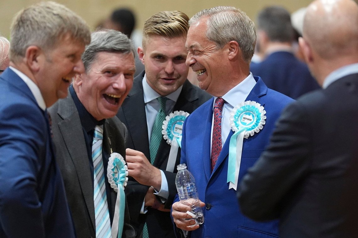 Reform UK leader Nigel Farage, second right, arrives at Clacton Leisure Centre in Clacton, England, during the count for the 2024 General Election, Friday July 5, 2024. Britain's Labour Party headed for a landslide victory Friday in a parliamentary election, an exit poll suggested, as voters punished the governing Conservatives after 14 years of economic and political upheaval. (Joe Giddens/PA Wire/PA via AP) Reform UK leader Nigel Farage, second right, arrives at Clacton Leisure Centre in Clacton, England, during the count for the 2024 General Election, Friday July 5, 2024. Britain's Labour Party headed for a landslide victory Friday in a parliamentary election, an exit poll suggested, as voters punished the governing Conservatives after 14 years of economic and political upheaval. (Joe Giddens/PA Wire/PA via AP)