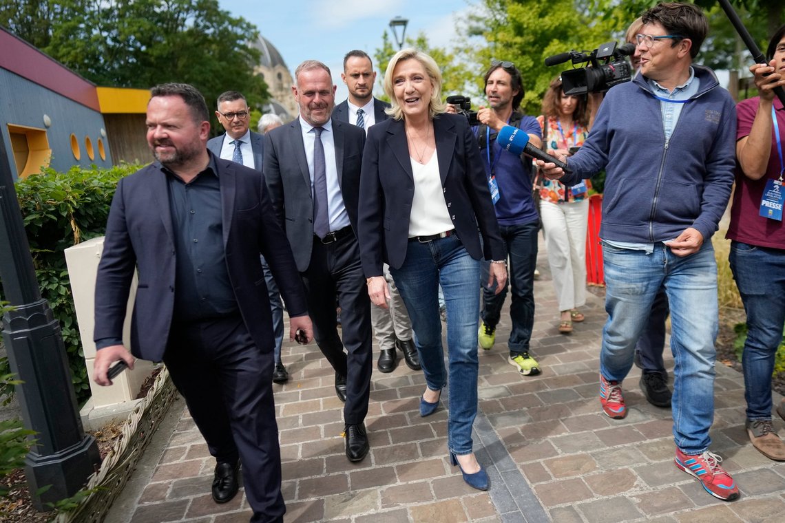 French far right leader Marine Le Pen, center, leaves after voting in the first round of the parliamentary election in Henin-Beaumont, northern France, Sunday, June 30, 2024. (AP Photo/Thibault Camus) French far right leader Marine Le Pen, center, leaves after voting in the first round of the parliamentary election in Henin-Beaumont, northern France, Sunday, June 30, 2024. (AP Photo/Thibault Camus)