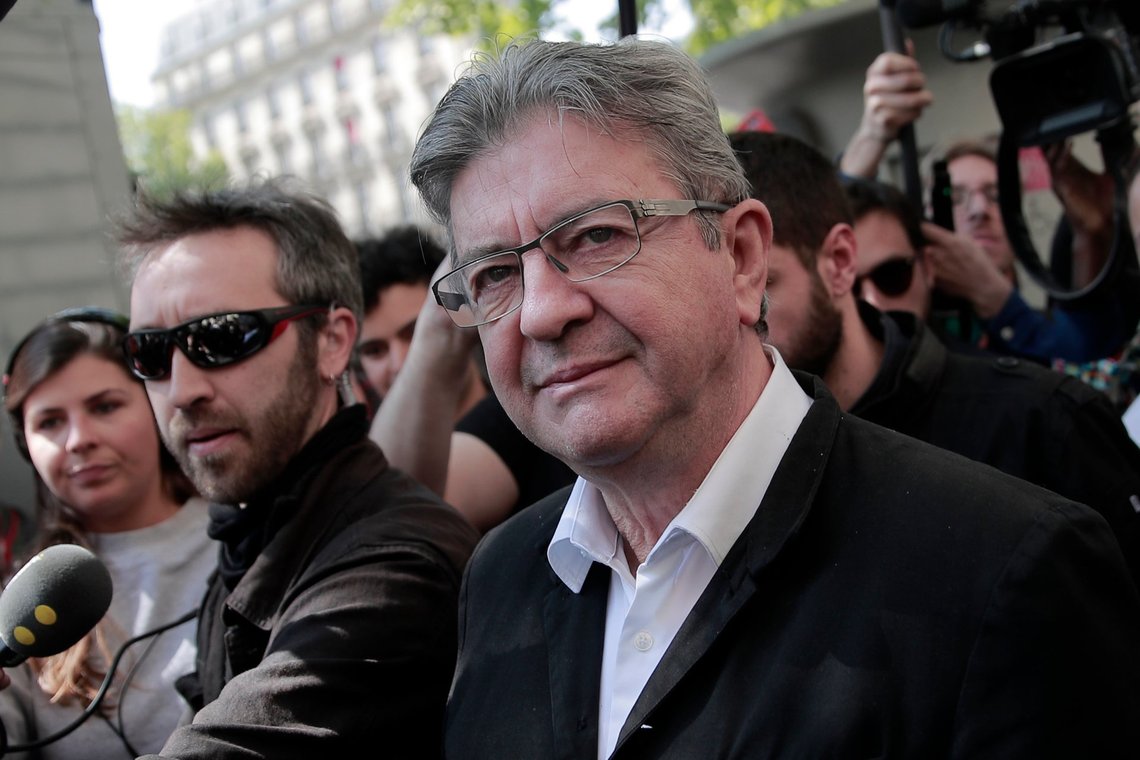 FILE - French far-left party leader and former candidate for the presidential election Jean-Luc Melenchon arrives, surrounded by medias, during a May Day demonstration march in Paris, France, Sunday, May 1, 2022. France's Greens and the party of far-left leader Jean-Luc Mélenchon reached an agreement Monday May 2, 2022 to join forces against newly reelected President Emmanuel Macron ahead of next month's parliamentary election. Both parties agreed not to compete against each other in the two rounds of voting on June 12 and 19. (AP Photo/Lewis Joly, Fiie) FILE - French far-left party leader and former candidate for the presidential election Jean-Luc Melenchon arrives, surrounded by medias, during a May Day demonstration march in Paris, France, Sunday, May 1, 2022. France's Greens and the party of far-left leader Jean-Luc Mélenchon reached an agreement Monday May 2, 2022 to join forces against newly reelected President Emmanuel Macron ahead of next month's parliamentary election. Both parties agreed not to compete against each other in the two rounds of voting on June 12 and 19. (AP Photo/Lewis Joly, Fiie)