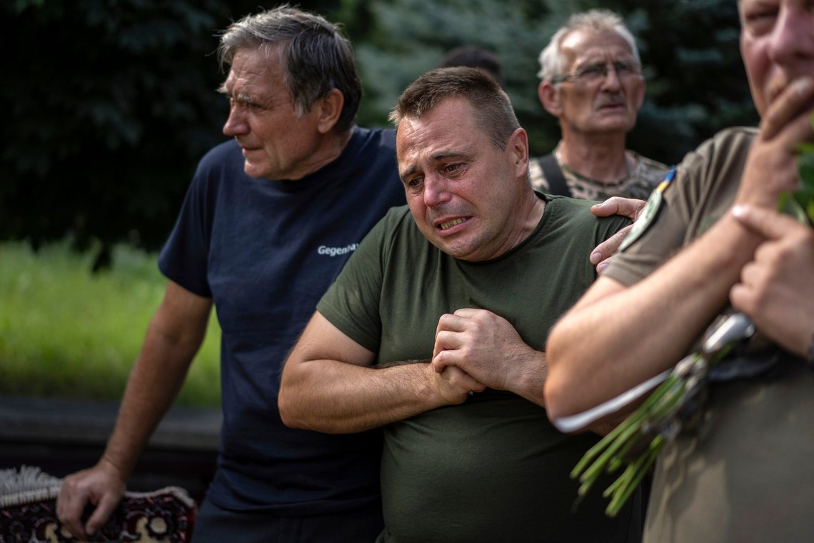 A Ukrainian serviceman reacts as he bids his last farewell to the fallen Ukrainian pilots and crew members of mi-8 military helicopters Volodymyr Rumar, Ivan Yaroviy, Yuriy Anisimov, Valentyn Vorobets, Victor Opanasiuk during a farewell ceremony in Poltava, Ukraine, Friday, Sept. 1, 2023. (AP Photo/Evgeniy Maloletka) A Ukrainian serviceman reacts as he bids his last farewell to the fallen Ukrainian pilots and crew members of mi-8 military helicopters Volodymyr Rumar, Ivan Yaroviy, Yuriy Anisimov, Valentyn Vorobets, Victor Opanasiuk during a farewell ceremony in Poltava, Ukraine, Friday, Sept. 1, 2023. (AP Photo/Evgeniy Maloletka)