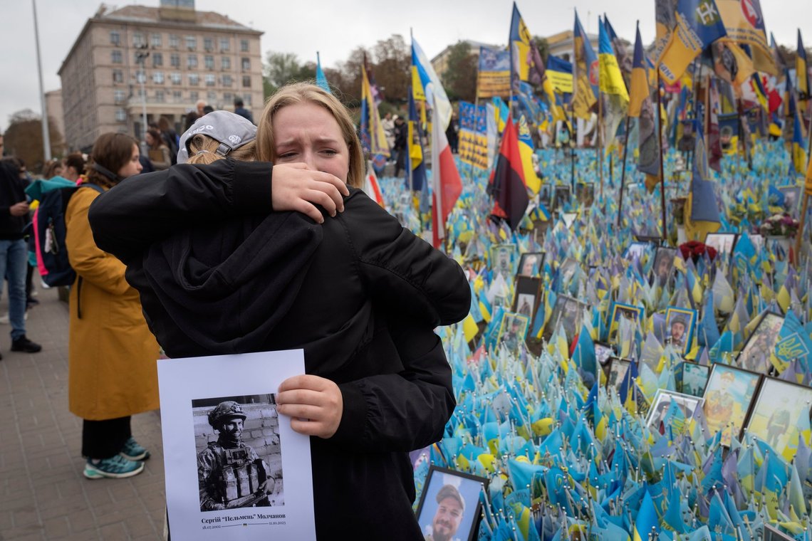 People react during a nationwide minute of silence in memory of fallen soldiers, who defended their homeland in war with Russia, on Defenders Day at the improvised war memorial in Independence square in Kyiv, Ukraine, Tuesday, Oct. 1, 2024. (AP Photo/Efrem Lukatsky) People react during a nationwide minute of silence in memory of fallen soldiers, who defended their homeland in war with Russia, on Defenders Day at the improvised war memorial in Independence square in Kyiv, Ukraine, Tuesday, Oct. 1, 2024. (AP Photo/Efrem Lukatsky)