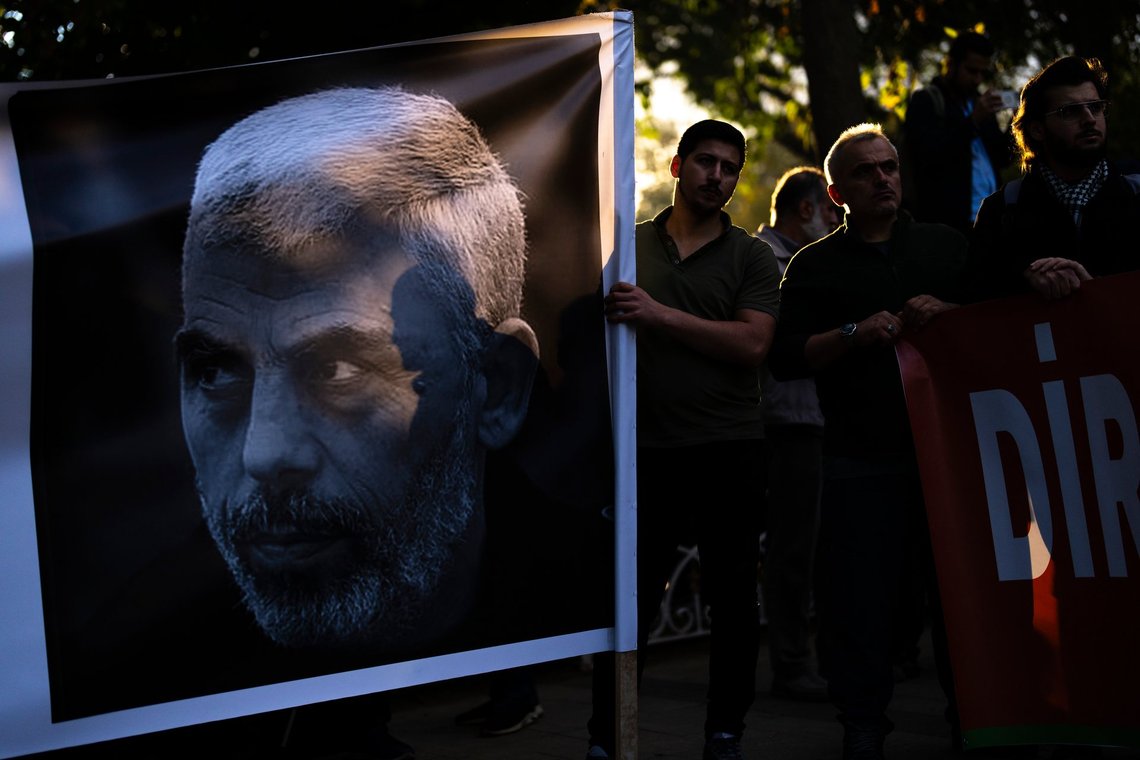 A man holds a banner with a photograph of Hamas leader Yahya Sinwar, who was killed by Israeli forces in Gaza on Wednesday, as he listens speeches with others during a pro- Palestinian protest in Istanbul, Turkey, Saturday, Oct. 19, 2024. (AP Photo/Francisco Seco) A man holds a banner with a photograph of Hamas leader Yahya Sinwar, who was killed by Israeli forces in Gaza on Wednesday, as he listens speeches with others during a pro- Palestinian protest in Istanbul, Turkey, Saturday, Oct. 19, 2024. (AP Photo/Francisco Seco)
