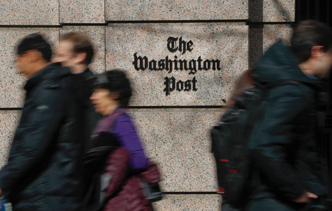 FILE - People walk by the One Franklin Square Building, home of The Washington Post newspaper, in downtown Washington, Feb. 21, 2019. New leaders of The Washington Post are being haunted by their past, with ethical questions raised about their actions as journalists in London that illustrate very different press traditions in the United States and England. (AP Photo/Pablo Martinez Monsivais, File) FILE - People walk by the One Franklin Square Building, home of The Washington Post newspaper, in downtown Washington, Feb. 21, 2019. New leaders of The Washington Post are being haunted by their past, with ethical questions raised about their actions as journalists in London that illustrate very different press traditions in the United States and England. (AP Photo/Pablo Martinez Monsivais, File)
