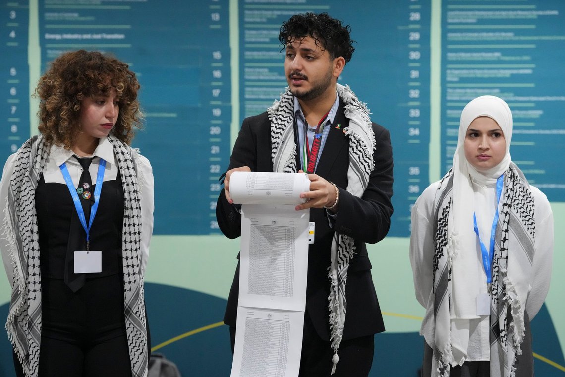 Activists including Mohammed Usrof, center, participate in a demonstration where they say names of victims of genocide are read at the COP29 U.N. Climate Summit, Thursday, Nov. 14, 2024, in Baku, Azerbaijan. (AP Photo/Peter Dejong) Activists including Mohammed Usrof, center, participate in a demonstration where they say names of victims of genocide are read at the COP29 U.N. Climate Summit, Thursday, Nov. 14, 2024, in Baku, Azerbaijan. (AP Photo/Peter Dejong)