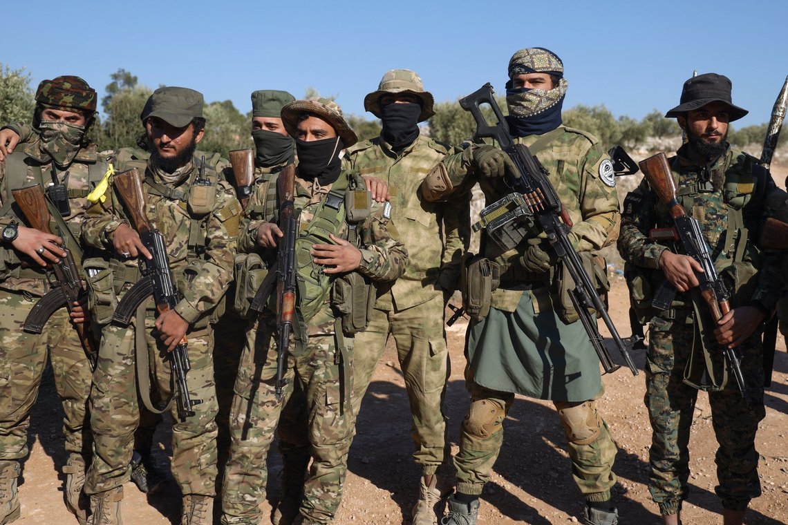 Syrian opposition fighters stand in formation after entering the village of Anjara, western outskirts of Aleppo, Syria, Thursday Nov. 28, 2024, part of their major offensive on government-controlled areas in the country's northwestern Syria. (AP Photo/Omar Albam) Syrian opposition fighters stand in formation after entering the village of Anjara, western outskirts of Aleppo, Syria, Thursday Nov. 28, 2024, part of their major offensive on government-controlled areas in the country's northwestern Syria. (AP Photo/Omar Albam)