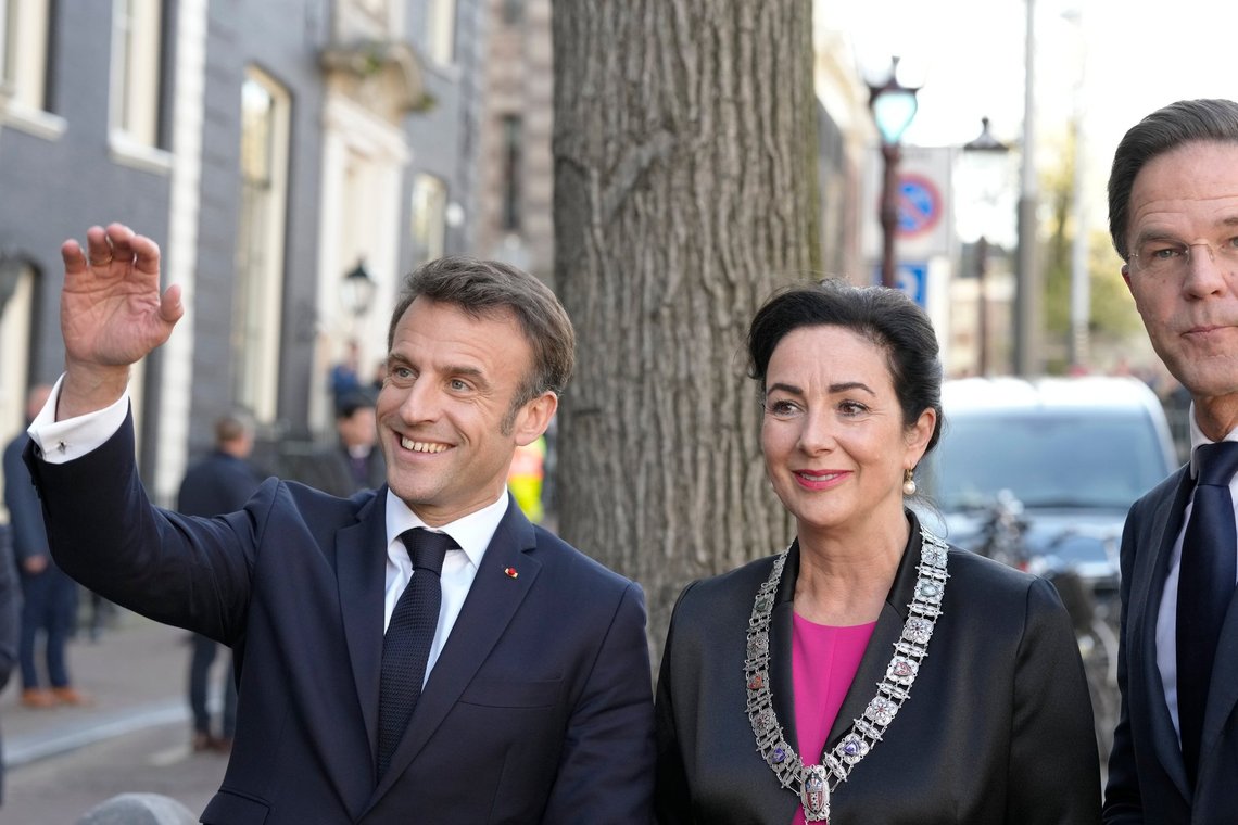 French President Emmanuel Macron, left, and Dutch Prime Minister Mark Rutte, right, arrive at the residence of mayor Femke Halsema, center, in Amsterdam, Netherlands, Wednesday, April 12, 2023. (AP Photo/Peter Dejong) French President Emmanuel Macron, left, and Dutch Prime Minister Mark Rutte, right, arrive at the residence of mayor Femke Halsema, center, in Amsterdam, Netherlands, Wednesday, April 12, 2023. (AP Photo/Peter Dejong)
