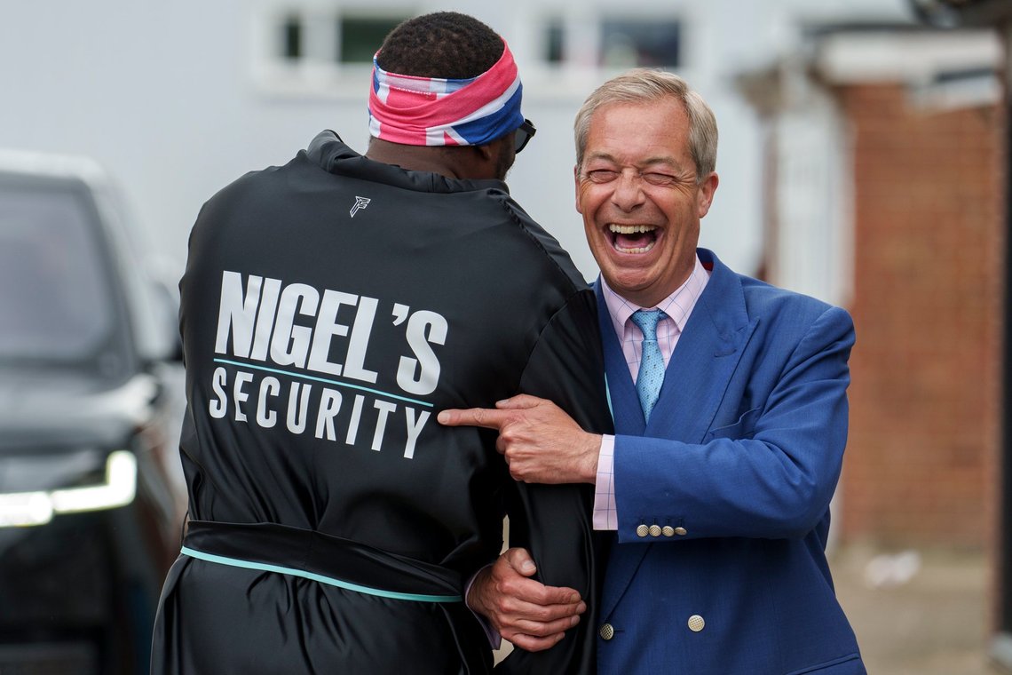 Nigel Farage, leader of the Reform UK party, right, shares a laugh with British boxer Derek Chisora during a visit to a boxing gym in Clacton-on-Sea, England, Wednesday, July 3, 2024. United Kingdom voters will cast ballots in a national election Thursday, passing judgment on Sunak's 20 months in office, and on the four Conservative prime ministers before him. (AP Photo/Vadim Ghirda) Nigel Farage, leader of the Reform UK party, right, shares a laugh with British boxer Derek Chisora during a visit to a boxing gym in Clacton-on-Sea, England, Wednesday, July 3, 2024. United Kingdom voters will cast ballots in a national election Thursday, passing judgment on Sunak's 20 months in office, and on the four Conservative prime ministers before him. (AP Photo/Vadim Ghirda)