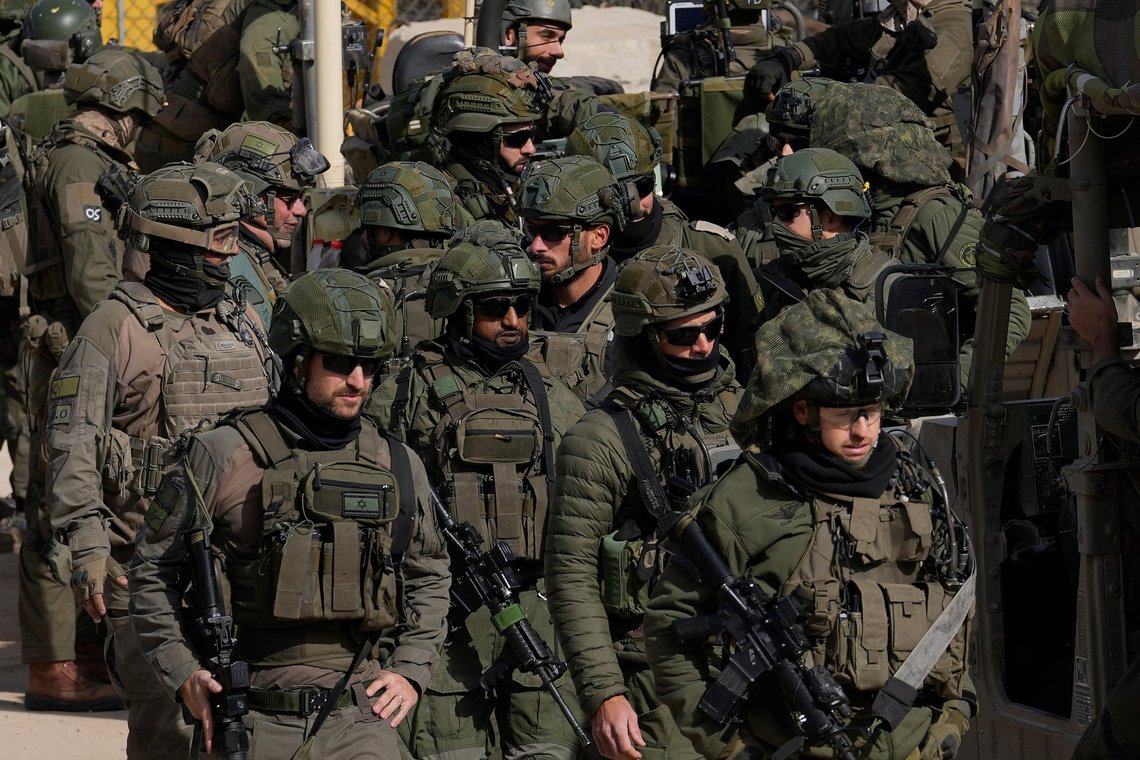 Israeli soldiers stand next to armoured vehicles before crossing the security fence, moving towards the so-called Alpha Line that separates the Israeli-controlled Golan Heights from Syria, in the town of Majdal Shams, Thursday, Dec. 12, 2024. (AP Photo/Matias Delacroix) Israeli soldiers stand next to armoured vehicles before crossing the security fence, moving towards the so-called Alpha Line that separates the Israeli-controlled Golan Heights from Syria, in the town of Majdal Shams, Thursday, Dec. 12, 2024. (AP Photo/Matias Delacroix)