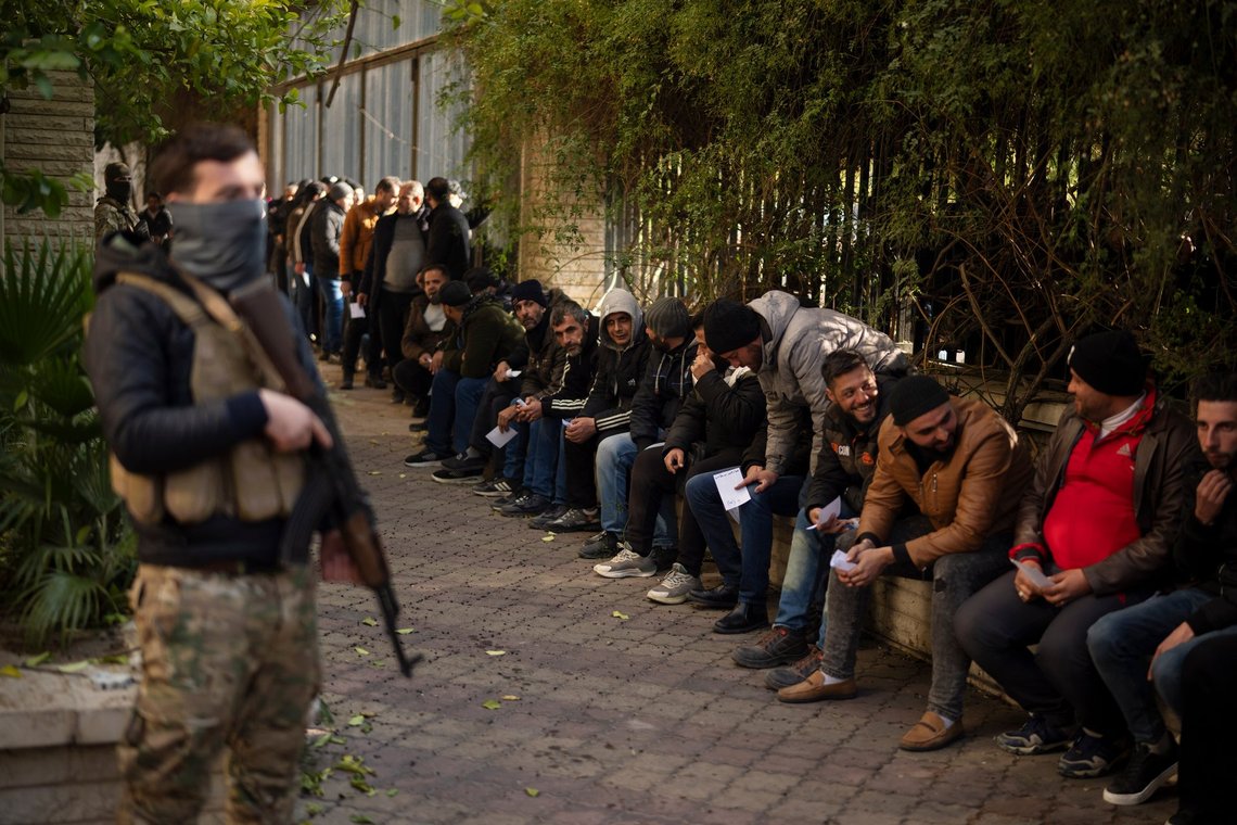 Members of Bashar Assad's army, or a pro-government militia, line up to register with Syrian rebels as part of an "identification and reconciliation process" in Damascus, Syria, Saturday, Dec. 21, 2024. (AP Photo/Leo Correa) Members of Bashar Assad's army, or a pro-government militia, line up to register with Syrian rebels as part of an "identification and reconciliation process" in Damascus, Syria, Saturday, Dec. 21, 2024. (AP Photo/Leo Correa)