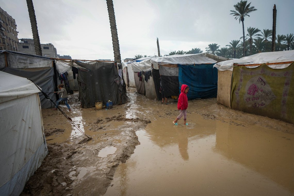 A young girl walks through a flooded street following overnight rainfall at the refugee tent camp for displaced Palestinians in Deir al-Balah, central Gaza Strip, Tuesday, Dec. 31, 2024. (AP Photo/Abdel Kareem Hana) A young girl walks through a flooded street following overnight rainfall at the refugee tent camp for displaced Palestinians in Deir al-Balah, central Gaza Strip, Tuesday, Dec. 31, 2024. (AP Photo/Abdel Kareem Hana)