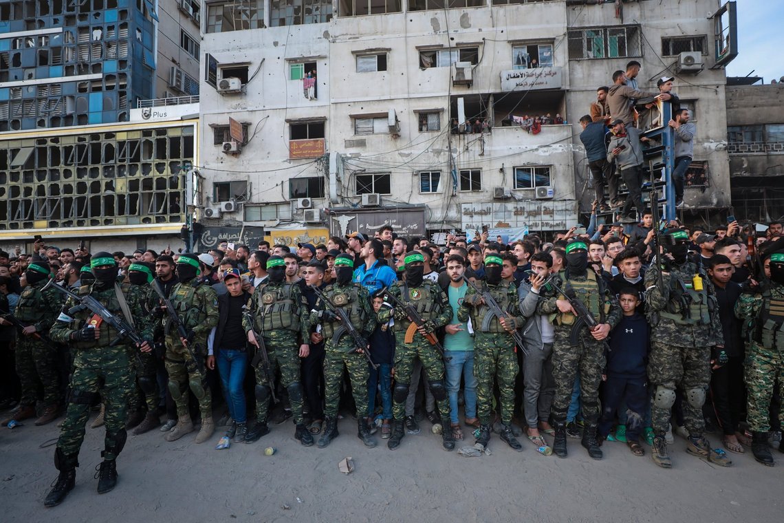 FILE - Fighters from the Qassam Brigades, the military wing of Hamas, control the crowd while Red Cross vehicles come to collect Israeli hostages to be released under a ceasefire agreement between Israel and Hamas, in Gaza City, Jan. 19, 2025. (AP Photo/Abed Hajjar, File) FILE - Fighters from the Qassam Brigades, the military wing of Hamas, control the crowd while Red Cross vehicles come to collect Israeli hostages to be released under a ceasefire agreement between Israel and Hamas, in Gaza City, Jan. 19, 2025. (AP Photo/Abed Hajjar, File)