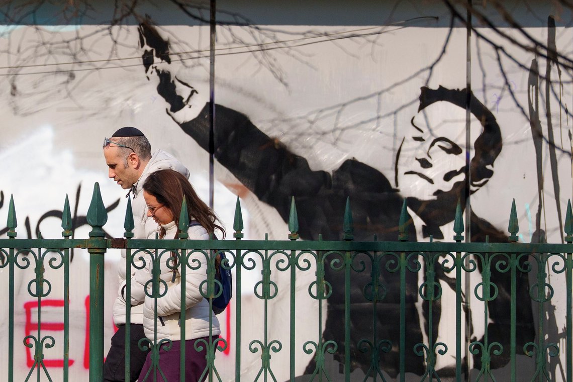 People walk by graffiti depicting Elon Musk, in Bucharest, Romania, Monday, March 3, 2025. (AP Photo/Andreea Alexandru) People walk by graffiti depicting Elon Musk, in Bucharest, Romania, Monday, March 3, 2025. (AP Photo/Andreea Alexandru)