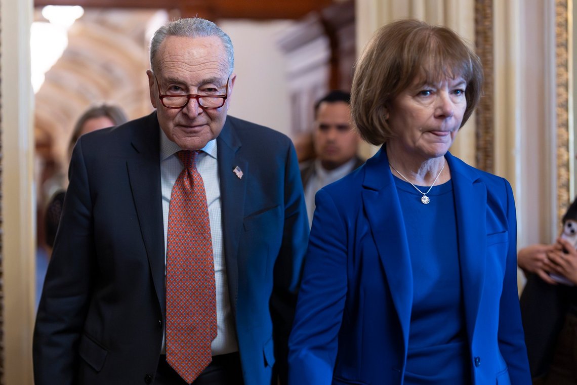 Senate Minority Leader Chuck Schumer, D-N.Y., walks with Sen. Tina Smith, D-Minn., right, as Senate Democrats gather behind closed doors to mount a last-ditch protest over a Republican-led spending bill that already passed the House, at the Capitol in Washington, Thursday, March 13, 2025. (AP Photo/J. Scott Applewhite) Senate Minority Leader Chuck Schumer, D-N.Y., walks with Sen. Tina Smith, D-Minn., right, as Senate Democrats gather behind closed doors to mount a last-ditch protest over a Republican-led spending bill that already passed the House, at the Capitol in Washington, Thursday, March 13, 2025. (AP Photo/J. Scott Applewhite)