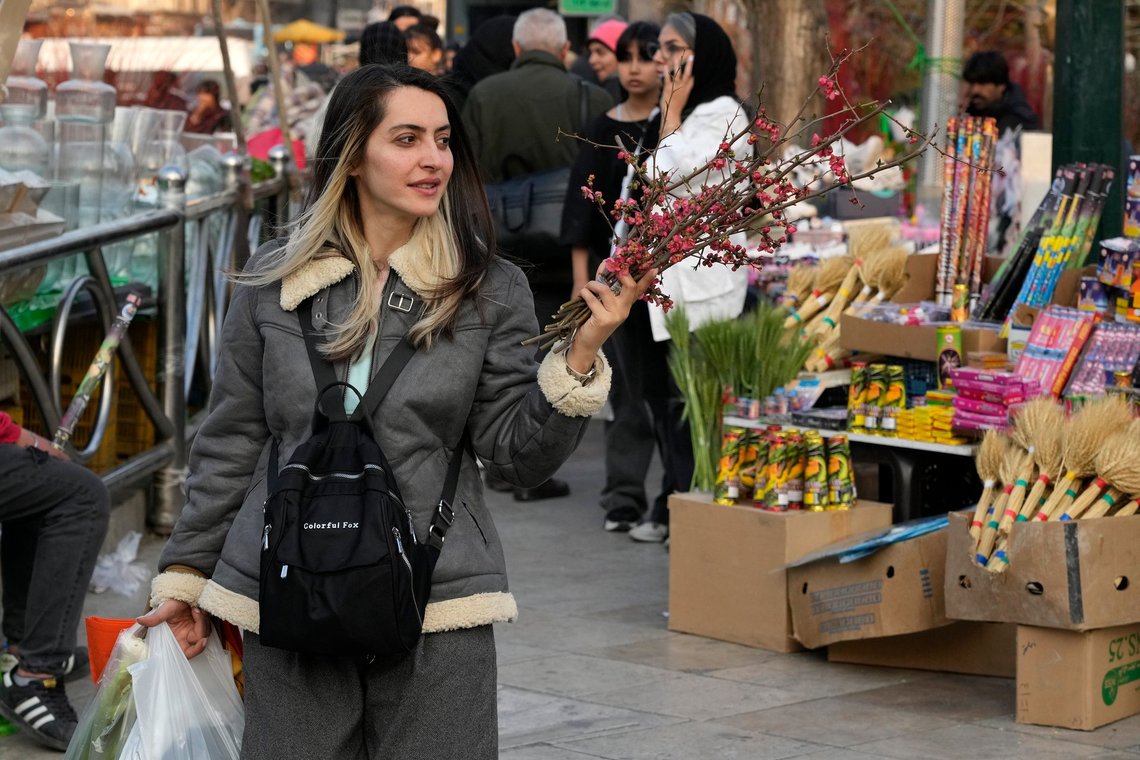 An Iranian woman carries her shopping bags including branches of a tree to decorate her New Year, or Nowruz, table at Tajrish traditional bazaar in northern Tehran, Iran, Saturday, March 15, 2025. The Persian new year, or Nowruz, which means "New Day", is the most important holiday for Iranians, it marks the beginning of the spring on vernal equinox. (AP Photo/Vahid Salemi) An Iranian woman carries her shopping bags including branches of a tree to decorate her New Year, or Nowruz, table at Tajrish traditional bazaar in northern Tehran, Iran, Saturday, March 15, 2025. The Persian new year, or Nowruz, which means "New Day", is the most important holiday for Iranians, it marks the beginning of the spring on vernal equinox. (AP Photo/Vahid Salemi)