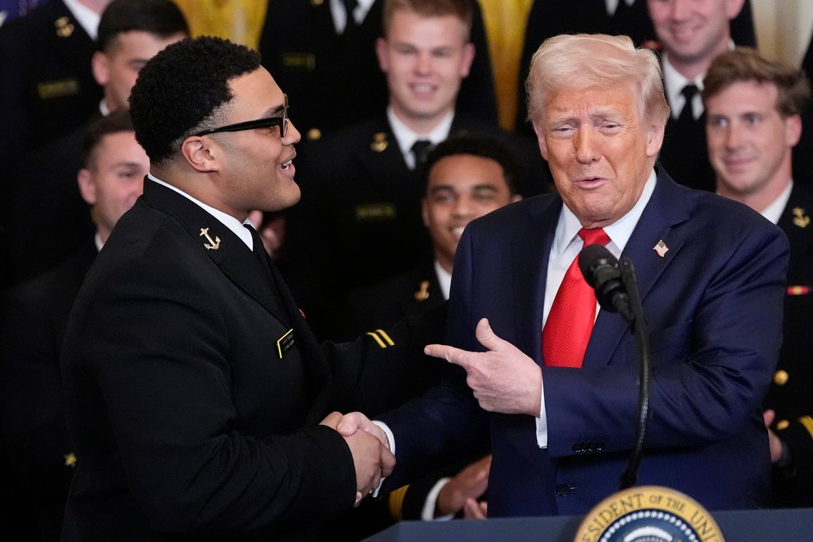 President Donald Trump shakes hands with Landon Robinson during the Commander-in-Chief trophy presentation to the Navy Midshipman football team in the East Room of the White House, Tuesday, April 15, 2025, in Washington. (AP Photo/Alex Brandon) President Donald Trump shakes hands with Landon Robinson during the Commander-in-Chief trophy presentation to the Navy Midshipman football team in the East Room of the White House, Tuesday, April 15, 2025, in Washington. (AP Photo/Alex Brandon)