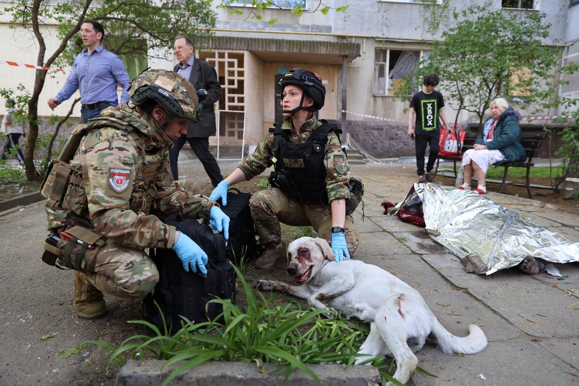 Police officers calm an injured dog near a body covered by an emergency blanket, outside a multi-story building damaged by a Russian strike in a residential neighborhood of Zaporizhzhia, Ukraine, April 22, 2025. (AP Photo/Kateryna Klochko) Police officers calm an injured dog near a body covered by an emergency blanket, outside a multi-story building damaged by a Russian strike in a residential neighborhood of Zaporizhzhia, Ukraine, April 22, 2025. (AP Photo/Kateryna Klochko)