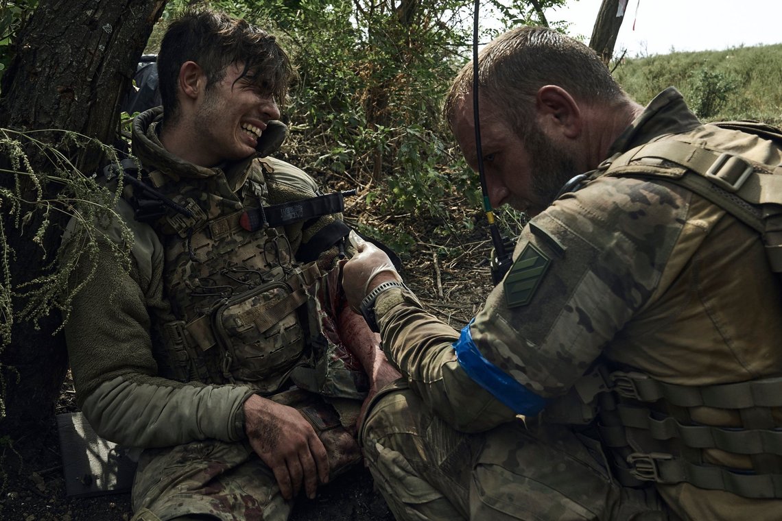 A soldier of Ukraine's 3rd Separate Assault Brigade gives first aid to his wounded comrade, call sign Polumya (Flame), 19, near Bakhmut, the site of fierce battles with the Russian forces in the Donetsk region, Ukraine, Monday, Sept. 4, 2023. (AP Photo/Libkos) A soldier of Ukraine's 3rd Separate Assault Brigade gives first aid to his wounded comrade, call sign Polumya (Flame), 19, near Bakhmut, the site of fierce battles with the Russian forces in the Donetsk region, Ukraine, Monday, Sept. 4, 2023. (AP Photo/Libkos)