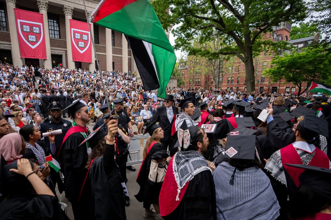 FILE - Graduating students hold Palestinian flags and chant as they walk out in protest over the 13 students who have been barred from graduating due to protest activities, during commencement in Harvard Yard, at Harvard University, in Cambridge, Mass., Thursday, May 23, 2024. (AP Photo/Ben Curtis, File) FILE - Graduating students hold Palestinian flags and chant as they walk out in protest over the 13 students who have been barred from graduating due to protest activities, during commencement in Harvard Yard, at Harvard University, in Cambridge, Mass., Thursday, May 23, 2024. (AP Photo/Ben Curtis, File)
