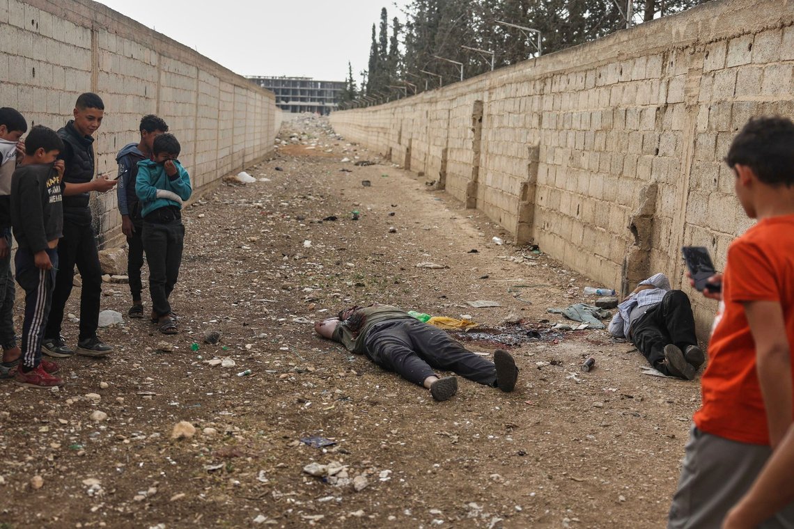EDS NOTE: GRAPHIC CONTENT - Syrian boys look at the bodies of the former Shanaya's town mayor Houssam Warawar and his son Haidar, who were killed in the town of Sahnaya, south of Damascus, Syria, Thursday, May 1, 2025, a day after clashes erupted between members of the minority Druze sect and pro-government fighters. (AP Photo/Ghaith Alsayed) EDS NOTE: GRAPHIC CONTENT - Syrian boys look at the bodies of the former Shanaya's town mayor Houssam Warawar and his son Haidar, who were killed in the town of Sahnaya, south of Damascus, Syria, Thursday, May 1, 2025, a day after clashes erupted between members of the minority Druze sect and pro-government fighters. (AP Photo/Ghaith Alsayed)