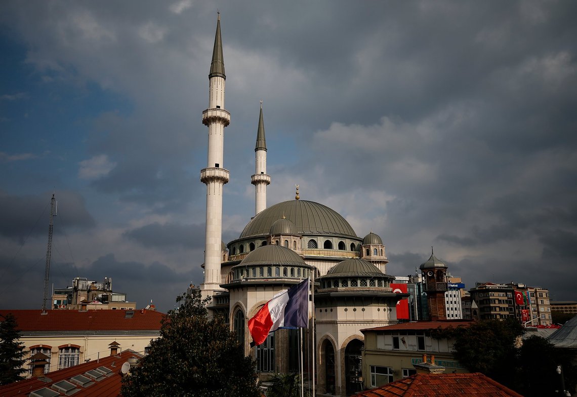 The French flag flies on the premises of France's consulate in Istanbul, with a mosque still under construction in the background, Wednesday, Oct. 28, 2020. Turkish officials railed against French satirical magazine Charlie Hebdo over its cover-page cartoon mocking Turkish President Recep Tayyip Erdogan and accused it of sowing "the seeds of hatred and animosity." The cartoon could further heighten tensions between Turkey and France, which erupted over French President Emmanuel Macron's firm stance against Islamism following the beheading of a teacher who showed his class caricatures of the Prophet Muhammad for a free speech class. (AP Photo/Emrah Gurel) The French flag flies on the premises of France's consulate in Istanbul, with a mosque still under construction in the background, Wednesday, Oct. 28, 2020. Turkish officials railed against French satirical magazine Charlie Hebdo over its cover-page cartoon mocking Turkish President Recep Tayyip Erdogan and accused it of sowing "the seeds of hatred and animosity." The cartoon could further heighten tensions between Turkey and France, which erupted over French President Emmanuel Macron's firm stance against Islamism following the beheading of a teacher who showed his class caricatures of the Prophet Muhammad for a free speech class. (AP Photo/Emrah Gurel)