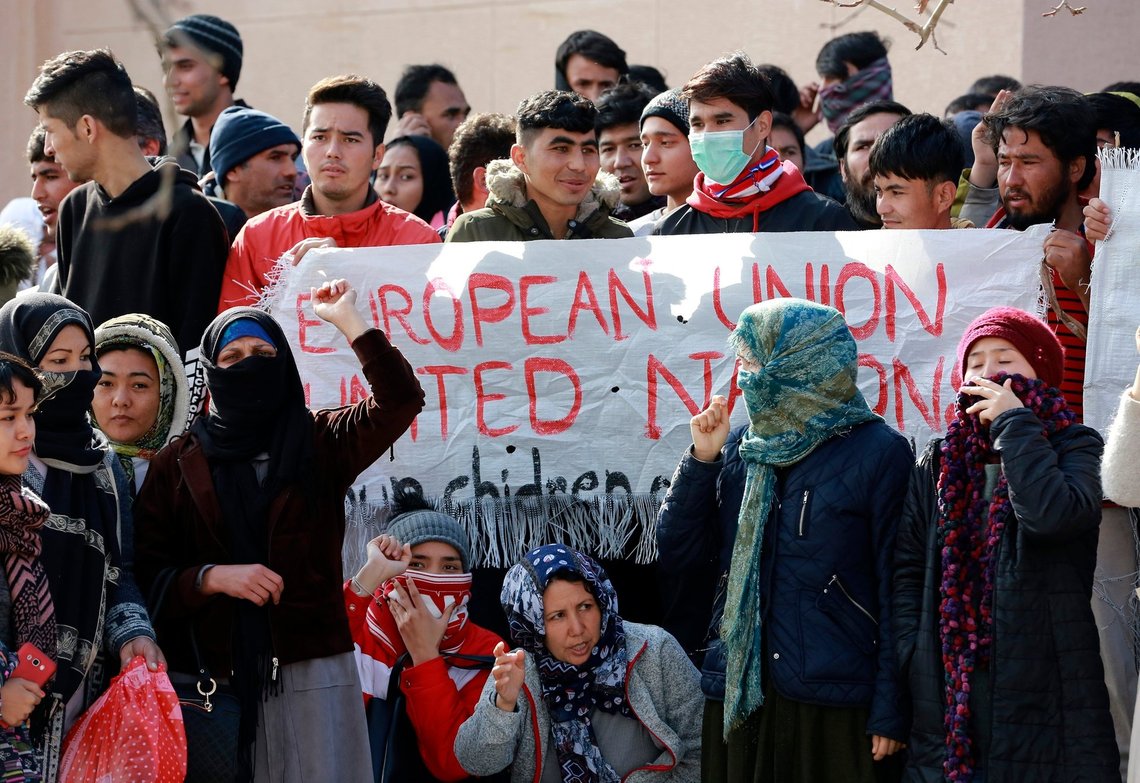 Migrants shout slogans during a protest in Mytilene port, on the northeastern Aegean island of Lesbos, Greece, on Tuesday, Feb. 4, 2020. Asylum seekers have demonstrated for a second day on the Greek island of Lesbos amid rising tension, protesting increasingly dire living conditions in and around the island's massively overcrowded migrant camp and delays in Greece's asylum process. (Manolis Lagoutaris/InTime News via AP) Migrants shout slogans during a protest in Mytilene port, on the northeastern Aegean island of Lesbos, Greece, on Tuesday, Feb. 4, 2020. Asylum seekers have demonstrated for a second day on the Greek island of Lesbos amid rising tension, protesting increasingly dire living conditions in and around the island's massively overcrowded migrant camp and delays in Greece's asylum process. (Manolis Lagoutaris/InTime News via AP)