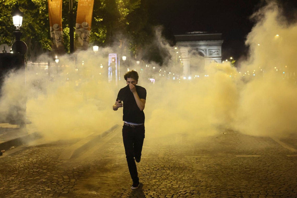 A man runs away from teargas during incidents on the Champs Elysees avenue following the Champions League final soccer match between Paris Saint-Germain and Inter Milan, Saturday, May 31, 2025 in Paris. (AP Photo/Thomas Padilla) A man runs away from teargas during incidents on the Champs Elysees avenue following the Champions League final soccer match between Paris Saint-Germain and Inter Milan, Saturday, May 31, 2025 in Paris. (AP Photo/Thomas Padilla)
