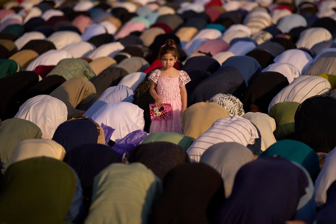 A child stands among people taking part in Eid al-Adha prayers at the Dinamo stadium in Bucharest, Romania, Friday, June 6, 2025. (AP Photo/Vadim Ghirda) A child stands among people taking part in Eid al-Adha prayers at the Dinamo stadium in Bucharest, Romania, Friday, June 6, 2025. (AP Photo/Vadim Ghirda)