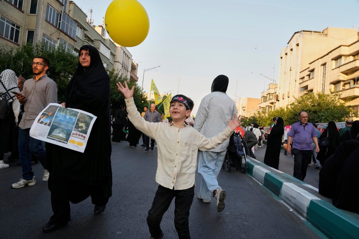 A boy plays with a balloon during a rally marking the Muslim Shiite holiday of Eid al-Ghadir, which commemorates the Prophet Muhammad naming his successor, Ali, who is revered as the first Shiite imam, in Tehran, Iran, Saturday, June 14, 2025. (AP Photo/Vahid Salemi) A boy plays with a balloon during a rally marking the Muslim Shiite holiday of Eid al-Ghadir, which commemorates the Prophet Muhammad naming his successor, Ali, who is revered as the first Shiite imam, in Tehran, Iran, Saturday, June 14, 2025. (AP Photo/Vahid Salemi)