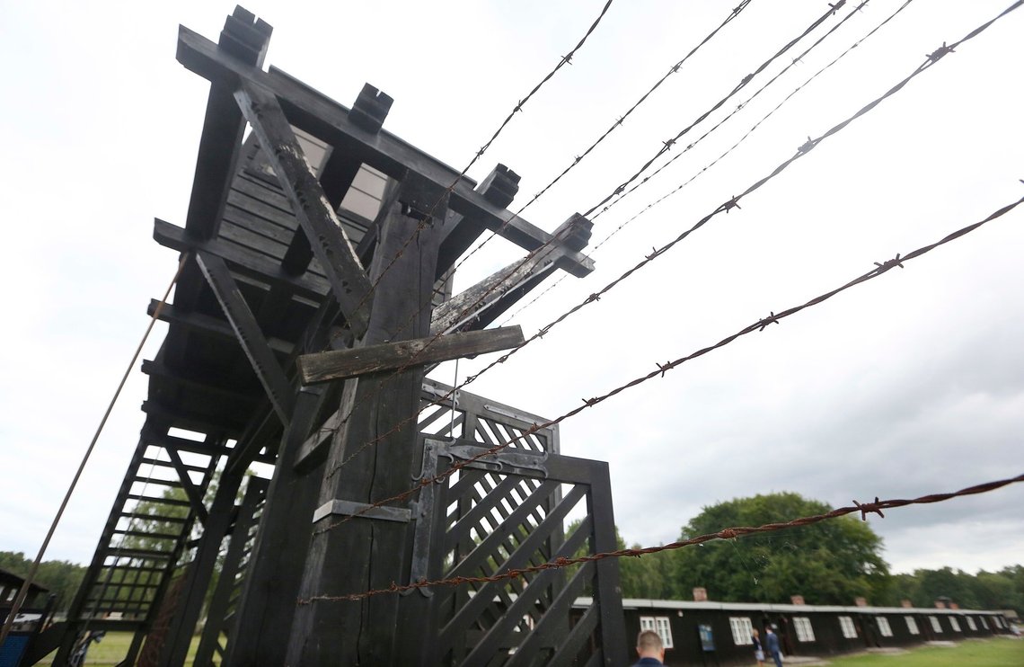 In this July 18, 2017 photo the wooden main gate leads into the former Nazi German Stutthof concentration camp in Sztutowo, Poland. A former SS guard is to go on trial in Germany on charges of accessory to murder for serving at the Nazis' Stutthof concentration camp. The 94-year-old, who hasn't been identified due to German privacy laws, is accused of working as a guard at the camp from June 1942 to the beginning of September 1944. (AP Photo/Czarek Sokolowski) In this July 18, 2017 photo the wooden main gate leads into the former Nazi German Stutthof concentration camp in Sztutowo, Poland. A former SS guard is to go on trial in Germany on charges of accessory to murder for serving at the Nazis' Stutthof concentration camp. The 94-year-old, who hasn't been identified due to German privacy laws, is accused of working as a guard at the camp from June 1942 to the beginning of September 1944. (AP Photo/Czarek Sokolowski)