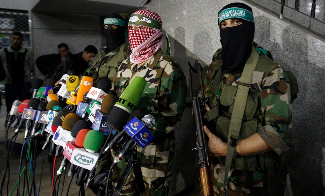 ** CORRECTS NUMBER OF PALESTINIANS KILLED ** Abu Obeida, center, spokesman for the Qassam Brigades, the Hamas' military wing, holds a press conference in Gaza City, Friday, March 26, 2010. Two Israeli soldiers and a Palestinian civilian were killed Friday as a gunbattle between troops and Palestinian militants widened into some of the fiercest fighting in the Gaza Strip since Israel's military offensive there last year. (AP Photo/Hatem Moussa) ** CORRECTS NUMBER OF PALESTINIANS KILLED ** Abu Obeida, center, spokesman for the Qassam Brigades, the Hamas' military wing, holds a press conference in Gaza City, Friday, March 26, 2010. Two Israeli soldiers and a Palestinian civilian were killed Friday as a gunbattle between troops and Palestinian militants widened into some of the fiercest fighting in the Gaza Strip since Israel's military offensive there last year. (AP Photo/Hatem Moussa)