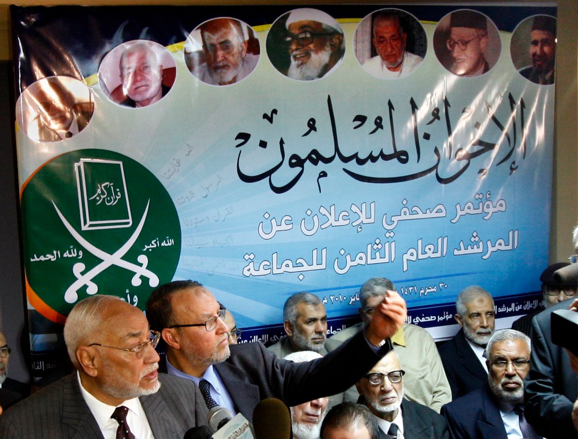 In this Jan.16, 2010 picture Muslim Brotherhood former supreme guide Mohammed Mahdi Akef, left, and senior member Essam al-Erian second left, gesture during a presser in Cairo Egypt under a billboard showing the group's founder Hassan al-Banna, top right, and its supreme guides. The group, founded in 1928, was banned in 1954 on charges of using violence. But it has since renounced violence, expanded its international presence and participated in Egyptian elections as independents despite frequent crackdowns. Arabic read ' The Muslim Brotherhood'. Others are old group memebrs. (AP Photo/Amr Nabil) In this Jan.16, 2010 picture Muslim Brotherhood former supreme guide Mohammed Mahdi Akef, left, and senior member Essam al-Erian second left, gesture during a presser in Cairo Egypt under a billboard showing the group's founder Hassan al-Banna, top right, and its supreme guides. The group, founded in 1928, was banned in 1954 on charges of using violence. But it has since renounced violence, expanded its international presence and participated in Egyptian elections as independents despite frequent crackdowns. Arabic read ' The Muslim Brotherhood'. Others are old group memebrs. (AP Photo/Amr Nabil)