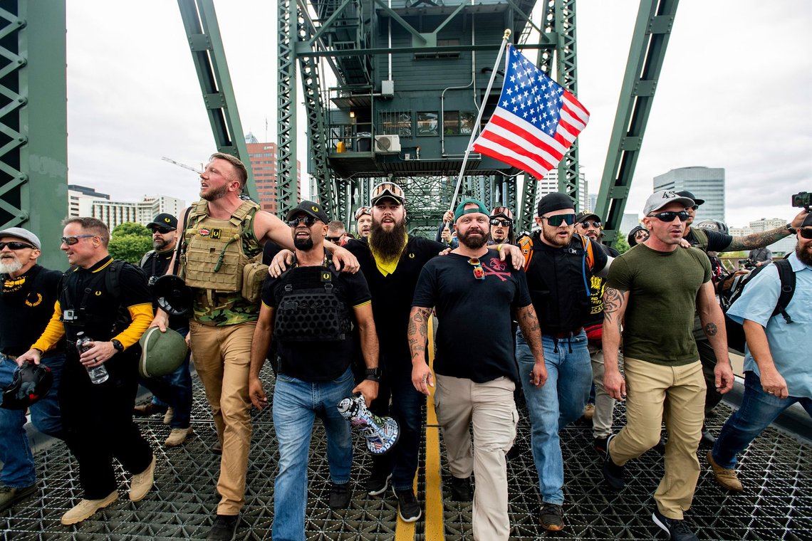 FILE - In this Aug. 17, 2019 file photo organizer Joe Biggs, in green hat, and Proud Boys Chairman Enrique Tarrio, holding megaphone, march with members of the Proud Boys and other right-wing demonstrators march across the Hawthorne Bridge during a rally in Portland, Ore. Proud Boys “thought leader” and organizer Joseph Biggs agreed to provide the FBI with information about “Antifa networks” in Florida and elsewhere after an agent contacted him in late July 2020 and arranged to meet at a restaurant, Biggs’ lawyer, J. Daniel Hull, wrote Monday, March 29, 2021, in a court filing. (AP Photo/Noah Berger,File) FILE - In this Aug. 17, 2019 file photo organizer Joe Biggs, in green hat, and Proud Boys Chairman Enrique Tarrio, holding megaphone, march with members of the Proud Boys and other right-wing demonstrators march across the Hawthorne Bridge during a rally in Portland, Ore. Proud Boys “thought leader” and organizer Joseph Biggs agreed to provide the FBI with information about “Antifa networks” in Florida and elsewhere after an agent contacted him in late July 2020 and arranged to meet at a restaurant, Biggs’ lawyer, J. Daniel Hull, wrote Monday, March 29, 2021, in a court filing. (AP Photo/Noah Berger,File)