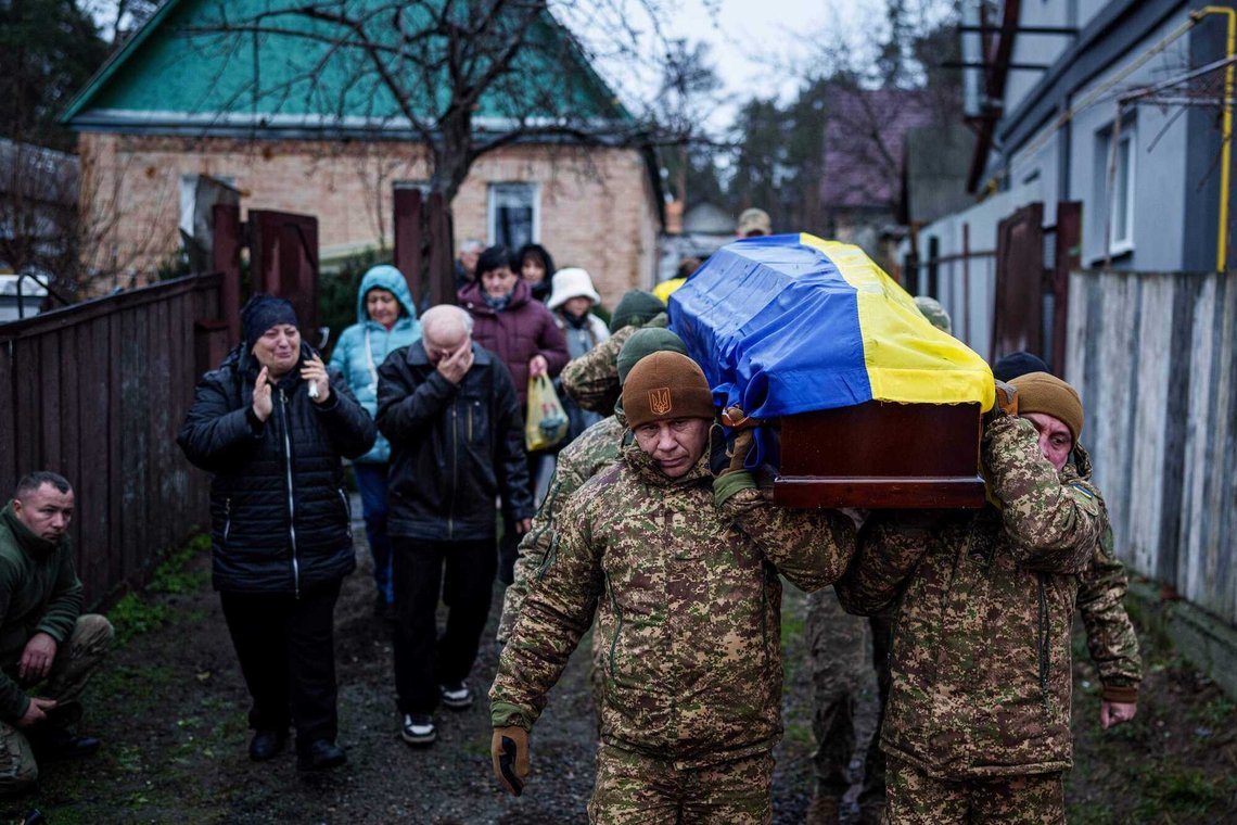 An honor guard carries the coffin of Ruslan Zhygunov, a Ukrainian serviceman, who was killed at the frontline near Rusyn Yar village, during his funeral ceremony in Hostomel, Ukraine, on Saturday, Nov. 22, 2025. (AP Photo/Evgeniy Maloletka) An honor guard carries the coffin of Ruslan Zhygunov, a Ukrainian serviceman, who was killed at the frontline near Rusyn Yar village, during his funeral ceremony in Hostomel, Ukraine, on Saturday, Nov. 22, 2025. (AP Photo/Evgeniy Maloletka)