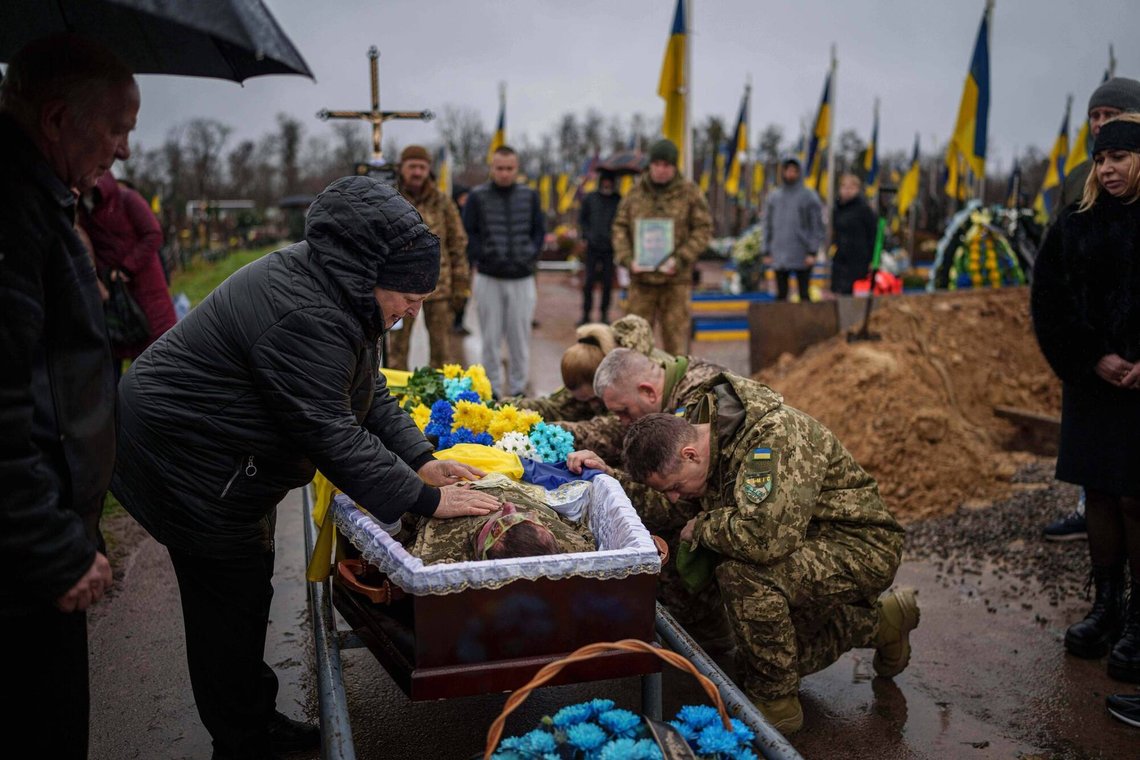 Natalia cries at the coffin of her son Ruslan Zhygunov, a Ukrainian serviceman, who was killed at the frontline near Rusyn Yar village, during his funeral ceremony in Hostomel, Ukraine, on Saturday, Nov. 22, 2025. (AP Photo/Evgeniy Maloletka) Natalia cries at the coffin of her son Ruslan Zhygunov, a Ukrainian serviceman, who was killed at the frontline near Rusyn Yar village, during his funeral ceremony in Hostomel, Ukraine, on Saturday, Nov. 22, 2025. (AP Photo/Evgeniy Maloletka)