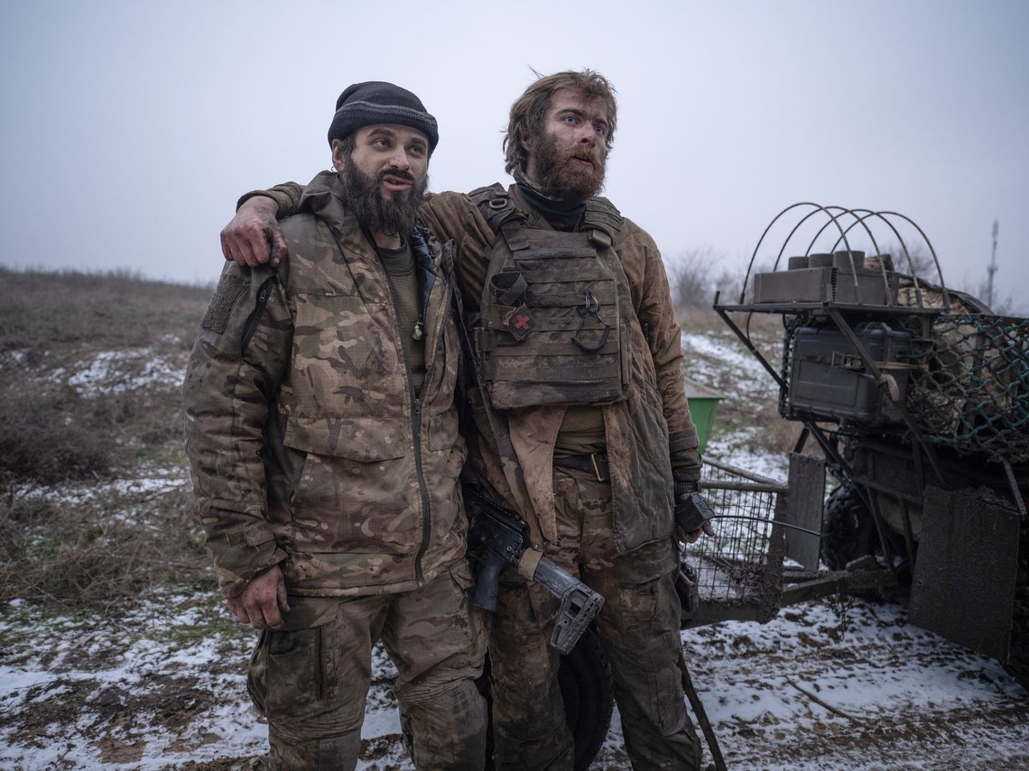 In this photo, taken Tuesday, Dec. 16, 2025 and provided by Ukraine's 93rd Kholodnyi Yar Separate Mechanized Brigade press service, Ukrainian soldiers Denis "Bars" and Dmytro "K2" hug each other after their return from a position where they fought for 130 days near Kostyantynivka, Donetsk region, Ukraine. (Iryna Rybakova/Ukraine's 93rd Mechanized Brigade via AP) In this photo, taken Tuesday, Dec. 16, 2025 and provided by Ukraine's 93rd Kholodnyi Yar Separate Mechanized Brigade press service, Ukrainian soldiers Denis "Bars" and Dmytro "K2" hug each other after their return from a position where they fought for 130 days near Kostyantynivka, Donetsk region, Ukraine. (Iryna Rybakova/Ukraine's 93rd Mechanized Brigade via AP)